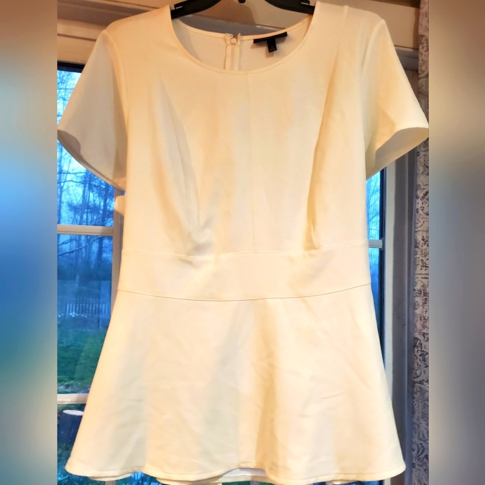 Lane Bryant cream/off white peplum dressy blouse with tie back and zipper.